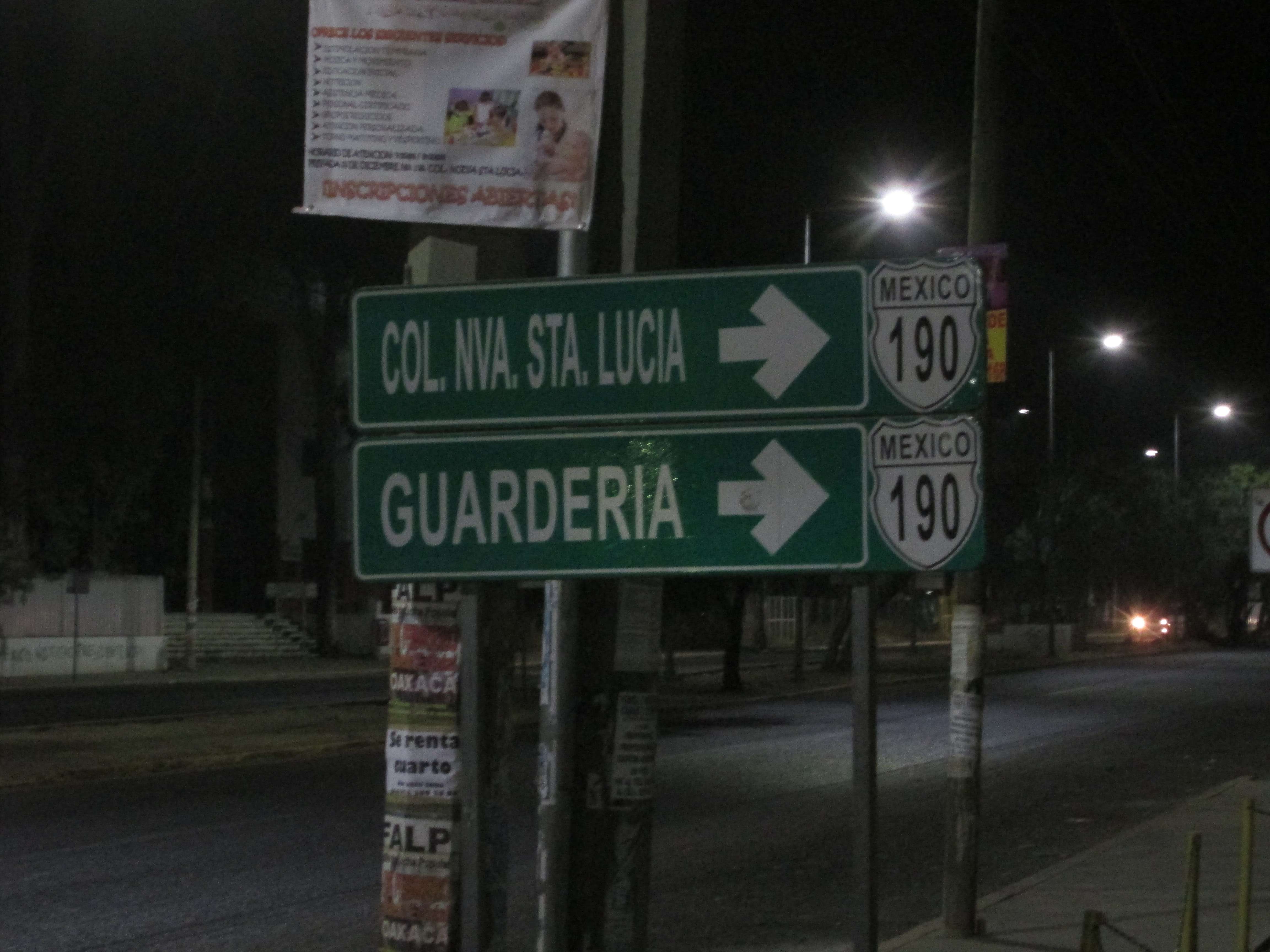 A photo of a road sign, pointing the way to highway 190, COL. NVA. STA. LUCIA, and GUARDERIA