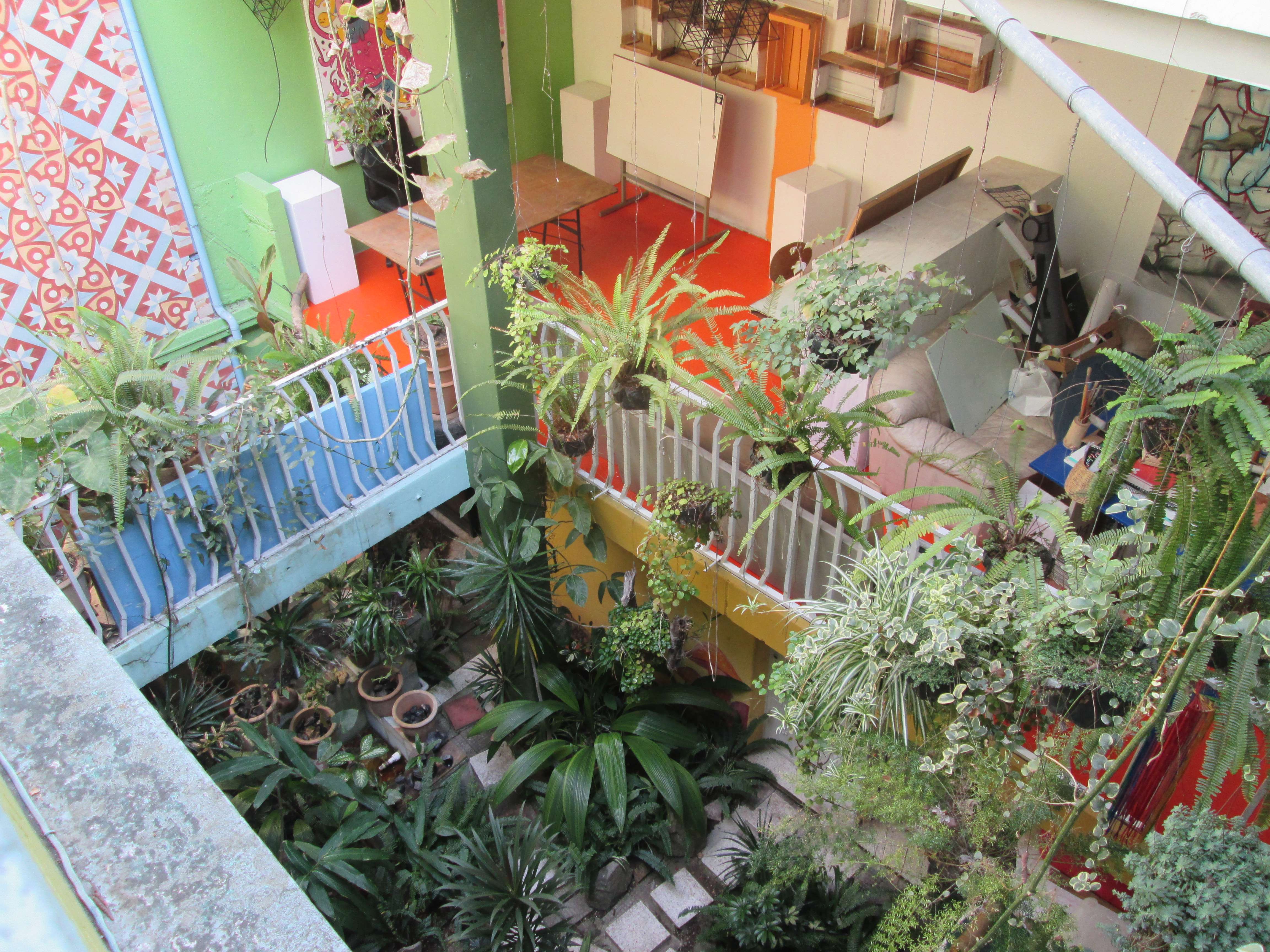 The courtyard, with many colorful mosaics and hanging plants