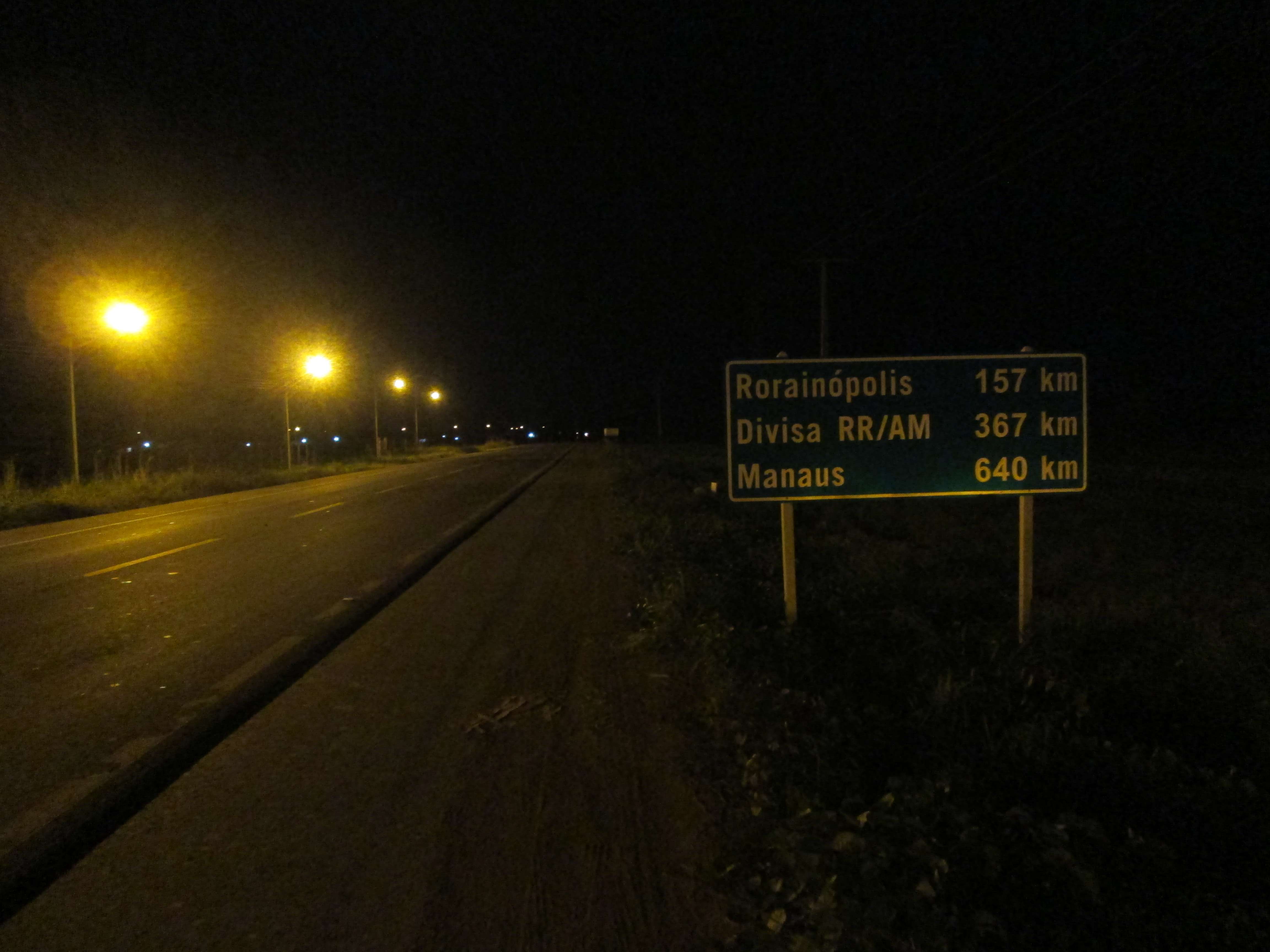 A photo of a sign at night: Manaus is 640km